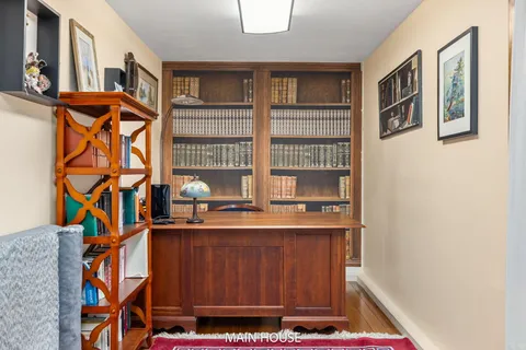 a bedroom with a bed and a dresser next to a window