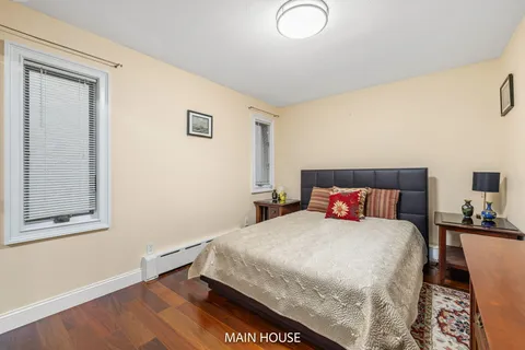 a view of a house with a yard and tree s