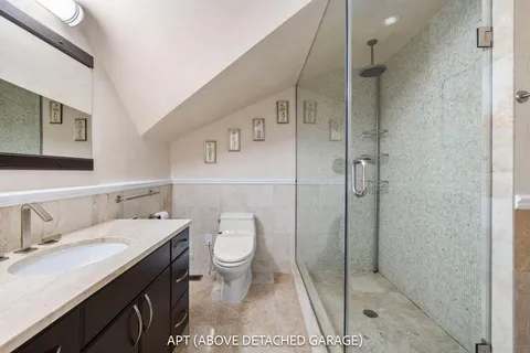 an aerial view of a house with swimming pool and garden