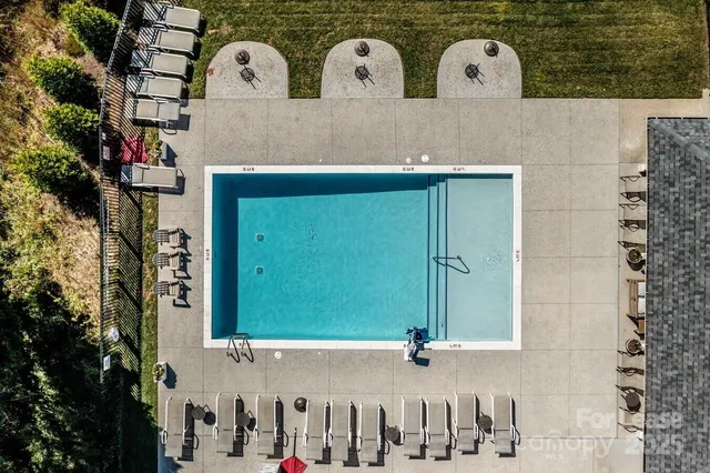 a kitchen with refrigerator and chairs