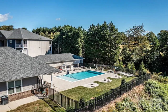 a view of a house with pool and chairs