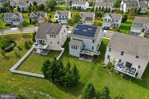 an aerial view of a house with a yard