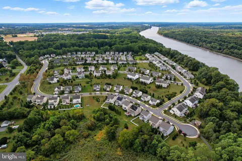 an aerial view of residential houses with outdoor space and ocean view