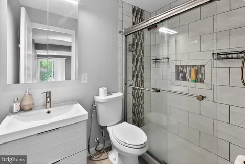 a bathroom with a sink toilet and shower