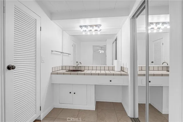a bathroom with a double vanity sink and a mirror