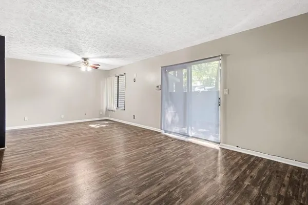 wooden floor in an empty room with a window