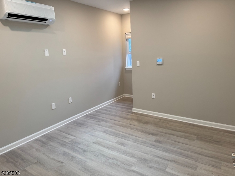 10 East Washington Avenue, Unit 302 Washington, NJ 07882 - Photo 4 of 4 a view of an empty room with wooden floor