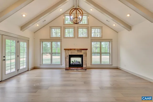 a view of an empty room with a window and a fireplace