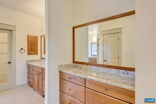 a bathroom with a sink a vanity and a mirror