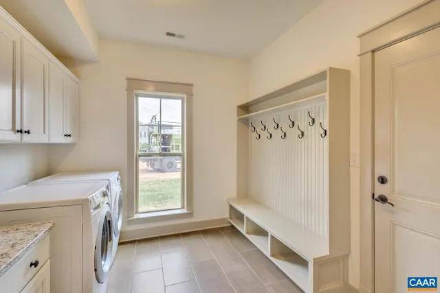 a view of utility room with closet and windows