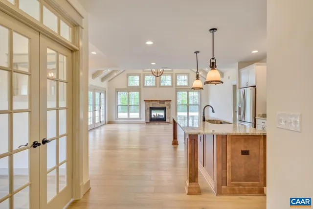 a view of empty room with a fireplace and windows