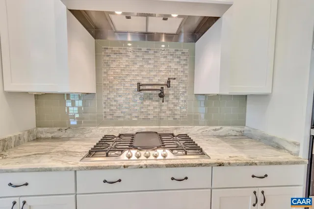 a stove top oven sitting inside of a kitchen