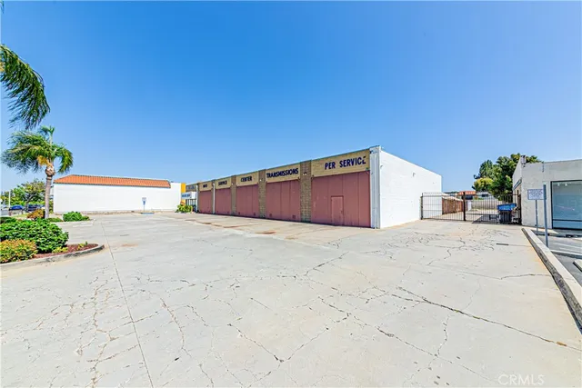 a view of garage with wooden fence