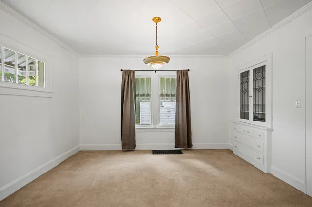 an empty room with windows and entrance