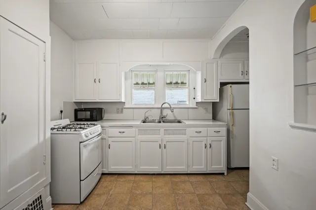 a kitchen with a stove sink and refrigerator