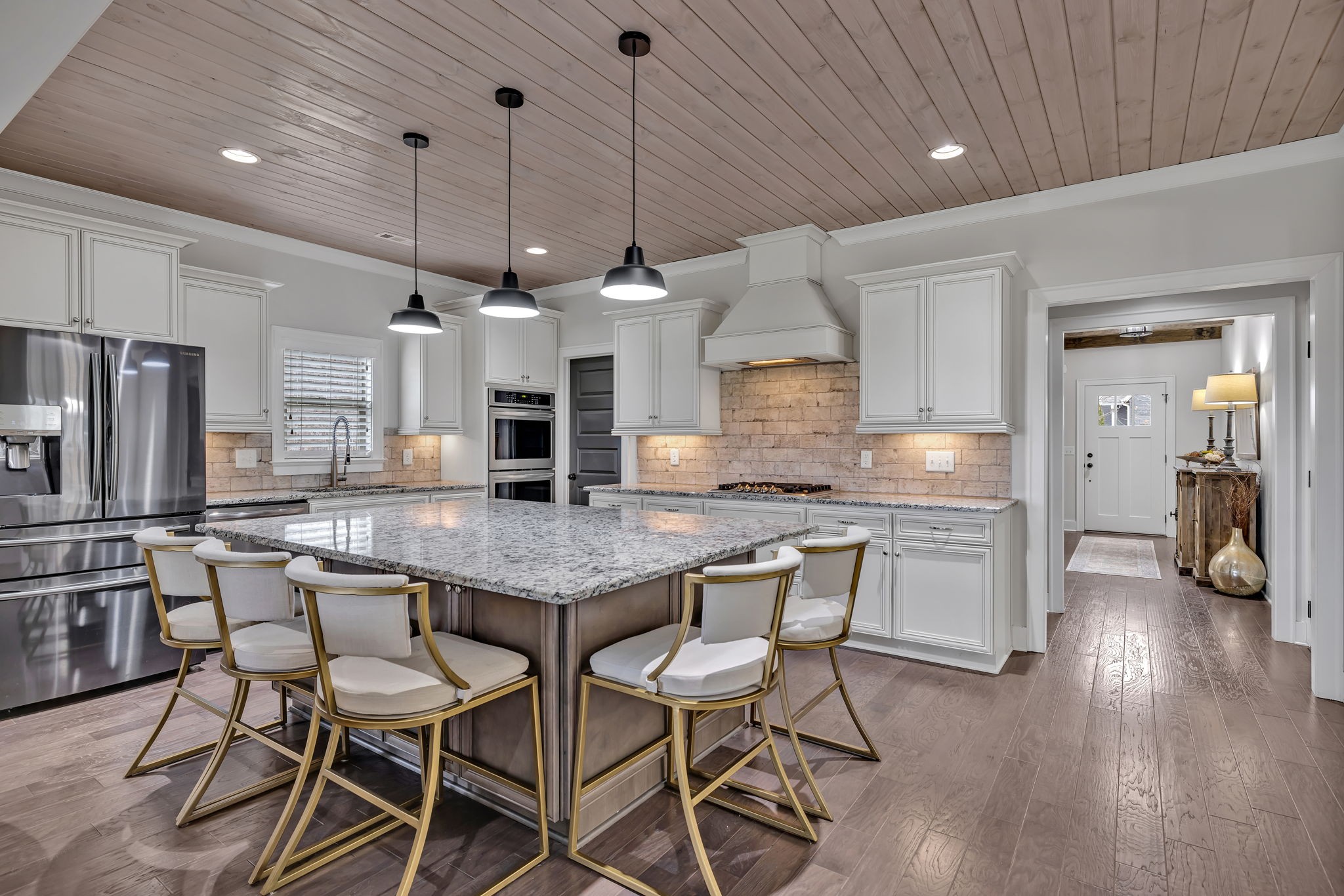 4049 Ryecroft Lane Franklin, TN 37064 - Photo 5 of 34 a kitchen with stainless steel appliances kitchen island granite countertop a table chairs in it and wooden floors