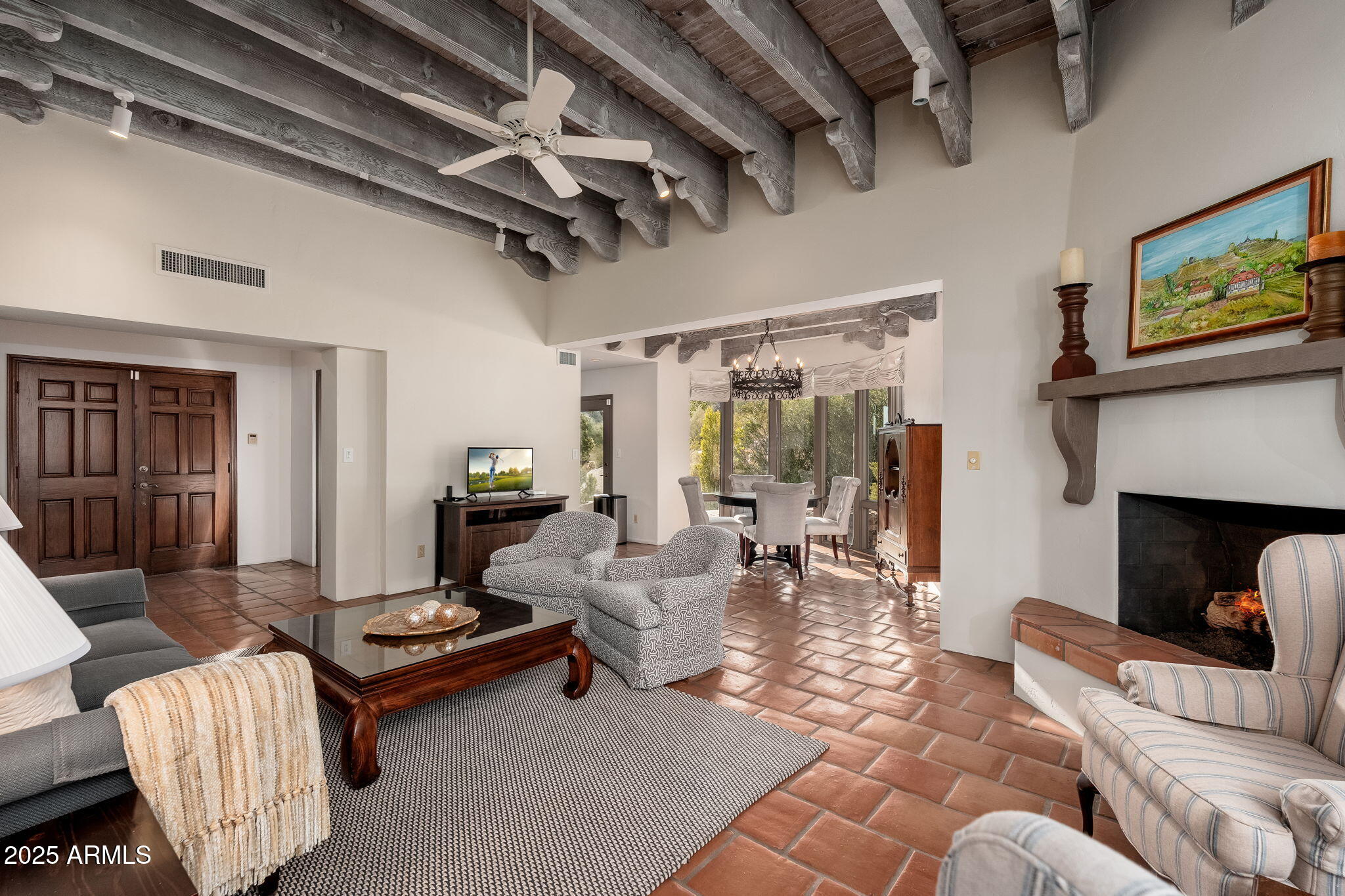 6527 East El Sendero Road Carefree, AZ 85377 - Photo 76 of 93 a living room with furniture a fireplace and a flat screen tv