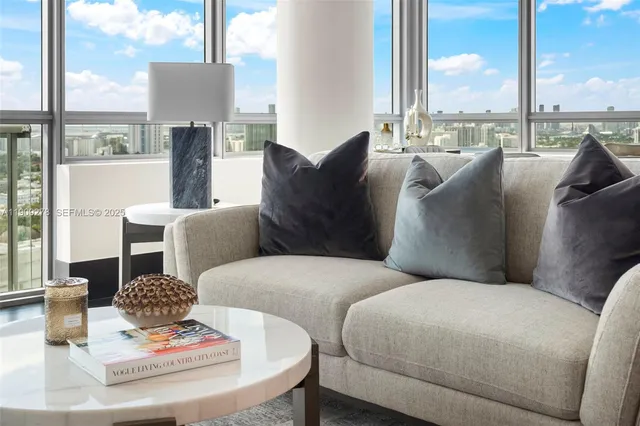 a living room with furniture and a chandelier