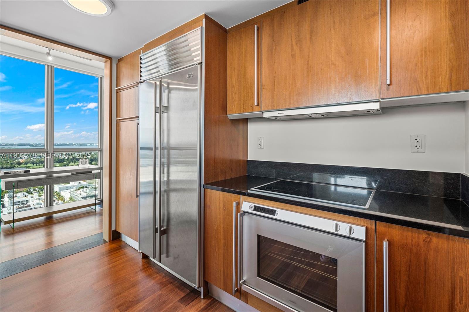101 20th Street, Unit 3202 Miami Beach, FL 33139 - Photo 23 of 54 a kitchen with a refrigerator stove and cabinets