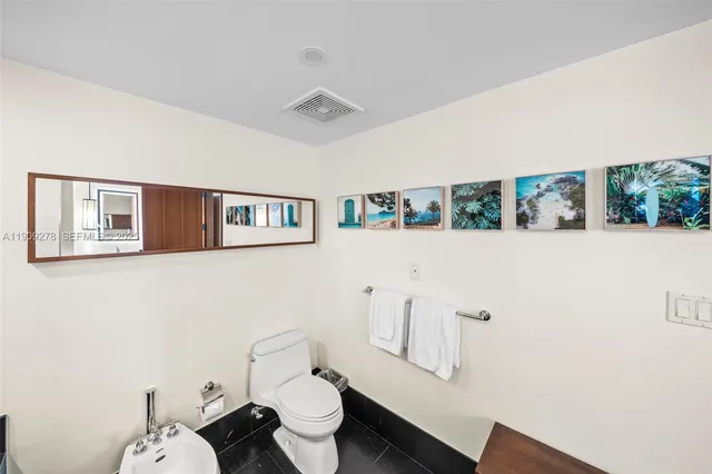 a bedroom with a bed couch and a large window