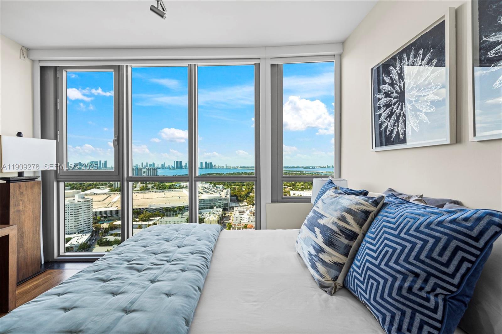 101 20th Street, Unit 3202 Miami Beach, FL 33139 - Photo 41 of 54 a spacious bedroom with a large bed and a large window