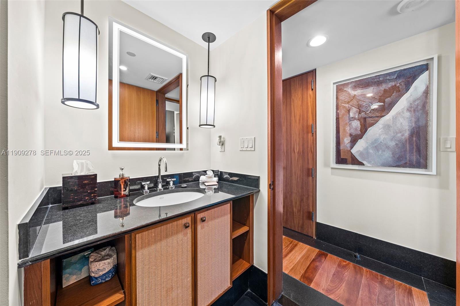 101 20th Street, Unit 3202 Miami Beach, FL 33139 - Photo 45 of 54 a bathroom with a sink and a mirror