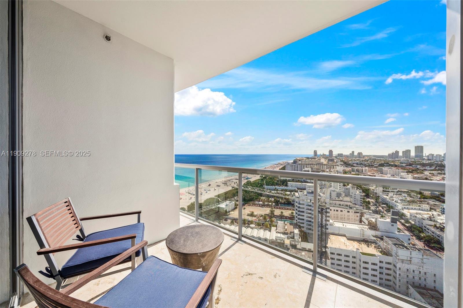 101 20th Street, Unit 3202 Miami Beach, FL 33139 - Photo 46 of 54 a view of a balcony with chair and wooden floor