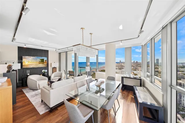 a living room with furniture large window and a table