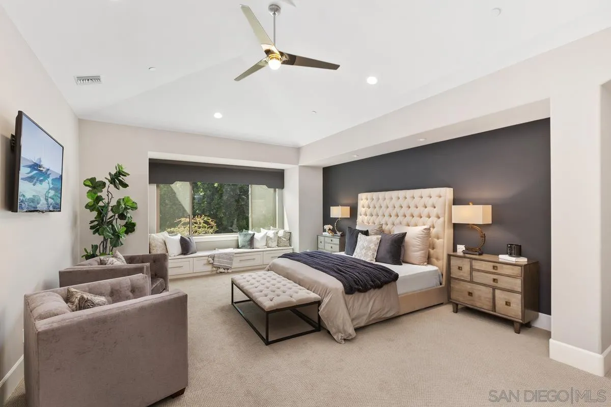 8330 Artesian Road San Diego, CA 92127 - Photo 16 of 26 a spacious bedroom with a bed couches and a flat tv screen