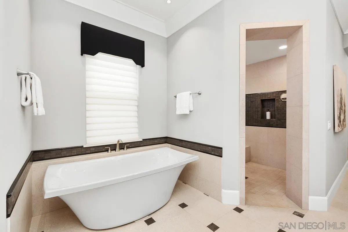 8330 Artesian Road San Diego, CA 92127 - Photo 18 of 26 a bathroom with a bathtub and a shower