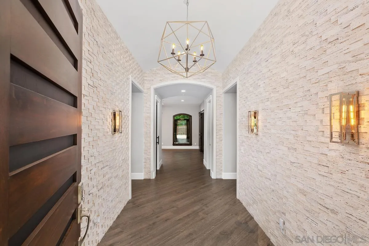 8330 Artesian Road San Diego, CA 92127 - Photo 5 of 26 a view of a hallway with wooden floor and staircase
