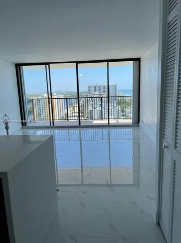 a view of a hallway with windows