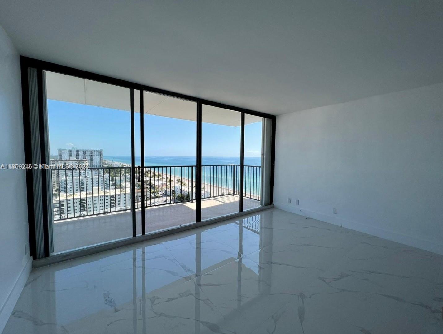 2101 South Ocean Drive, Unit 2004 Hollywood, FL 33019 - Photo 4 of 15 an empty room with sliding glass door and mountain view