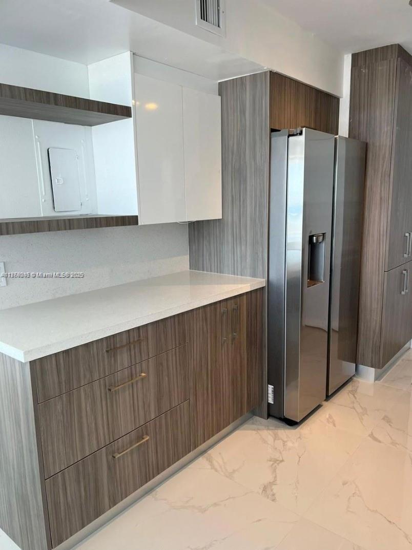 2101 South Ocean Drive, Unit 2004 Hollywood, FL 33019 - Photo 8 of 15 a kitchen with stainless steel appliances a refrigerator and a sink