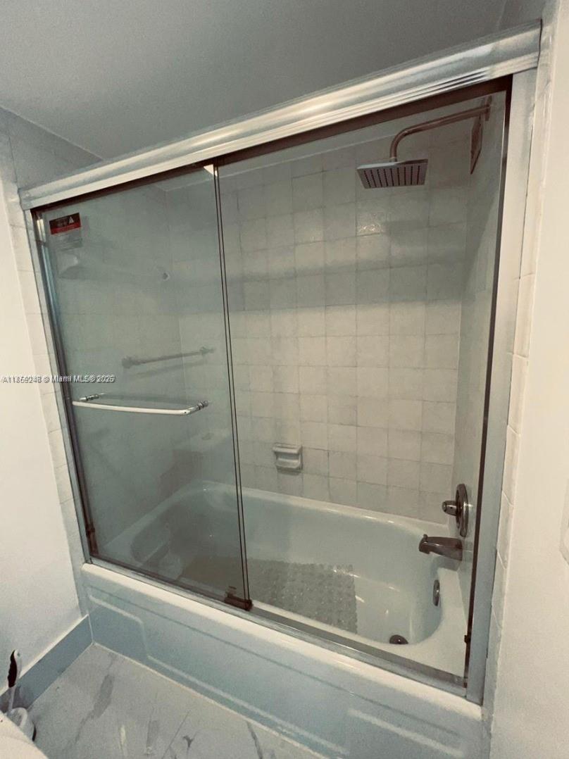 2101 South Ocean Drive, Unit 2004 Hollywood, FL 33019 - Photo 9 of 15 a bathroom with a glass shower door