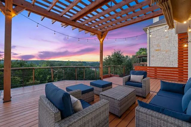 a view of a roof deck with couches and wooden floor
