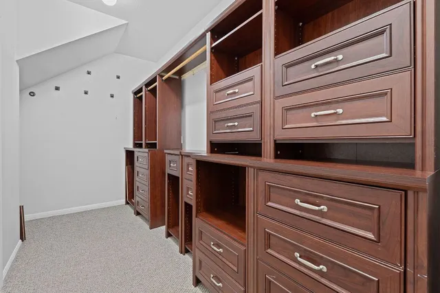 an empty room with closet and a ceiling fan