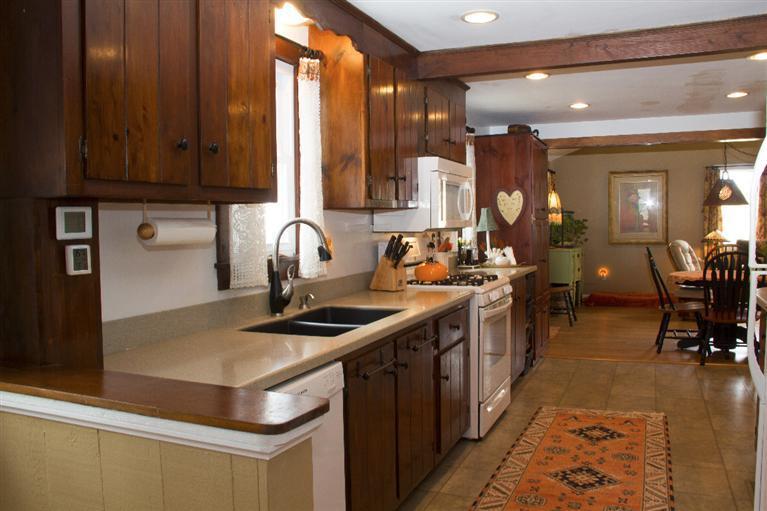 808 Old Stage Road Centerville, MA 02632 - Photo 12 of 35 a kitchen with a sink stove and cabinets