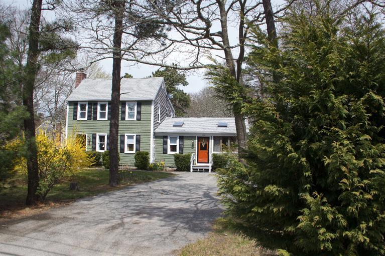 808 Old Stage Road Centerville, MA 02632 - Photo 3 of 35 a front view of a house with a garden