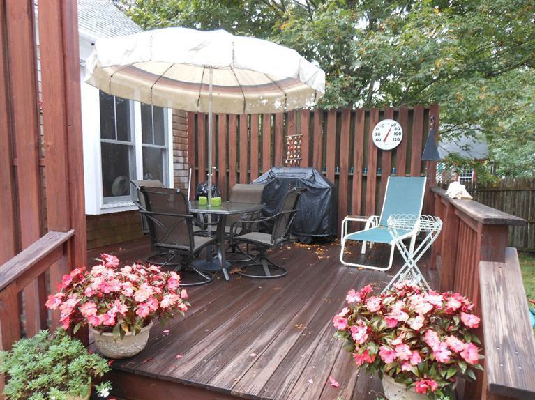 808 Old Stage Road Centerville, MA 02632 - Photo 32 of 35 a table and chairs in front of a house