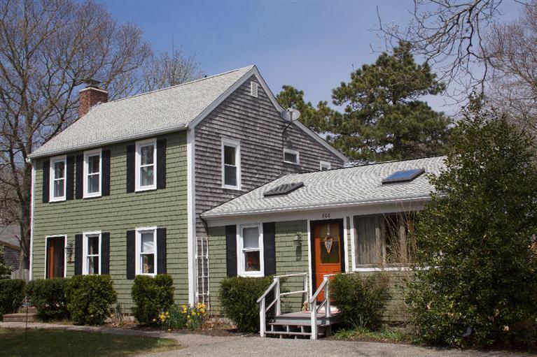 808 Old Stage Road Centerville, MA 02632 - Photo 35 of 35 a front view of a house with a garden and plants
