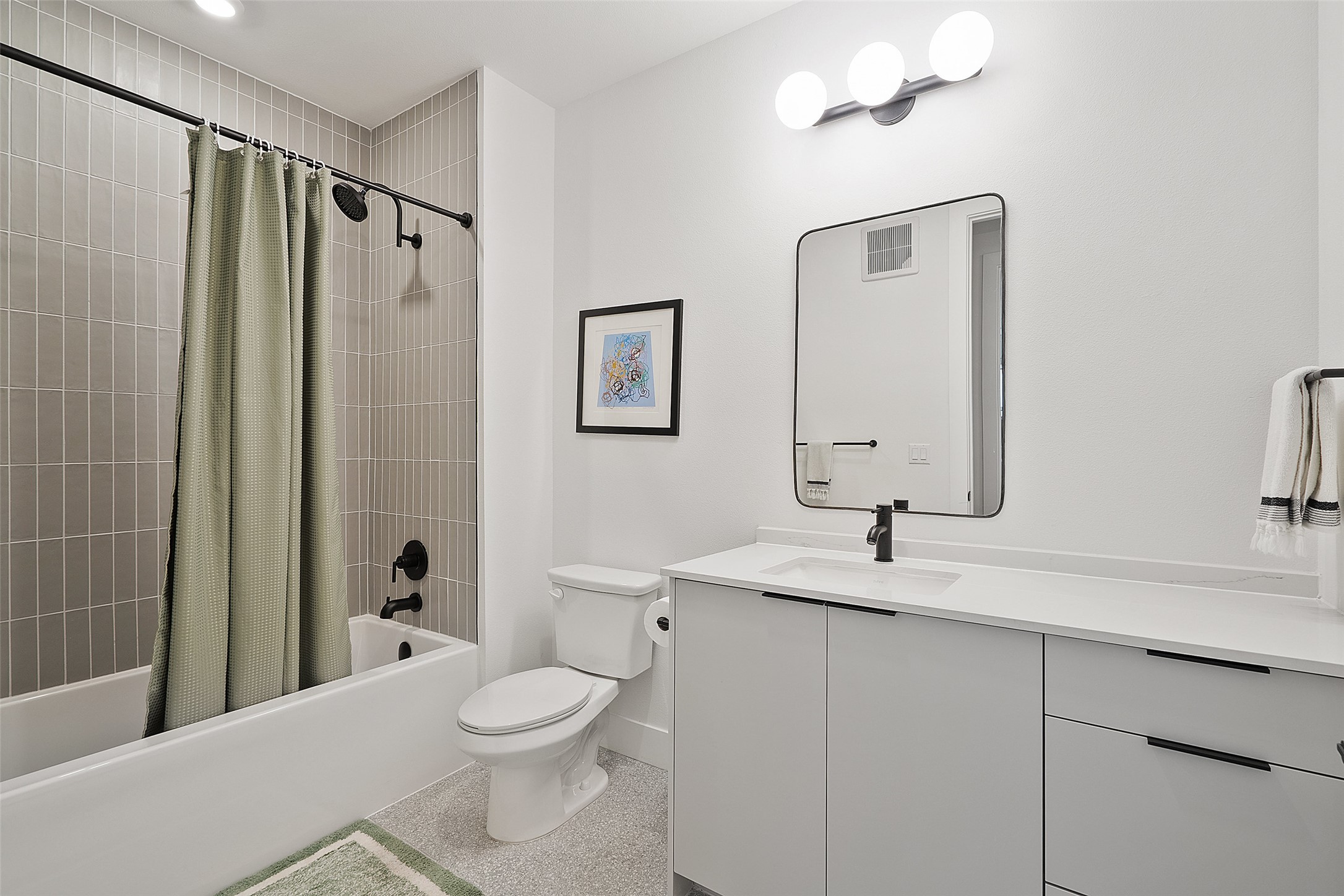 1701 Simond Avenue, Unit 305 Austin, TX 78723 - Photo 12 of 31 a bathroom with a sink a toilet and shower