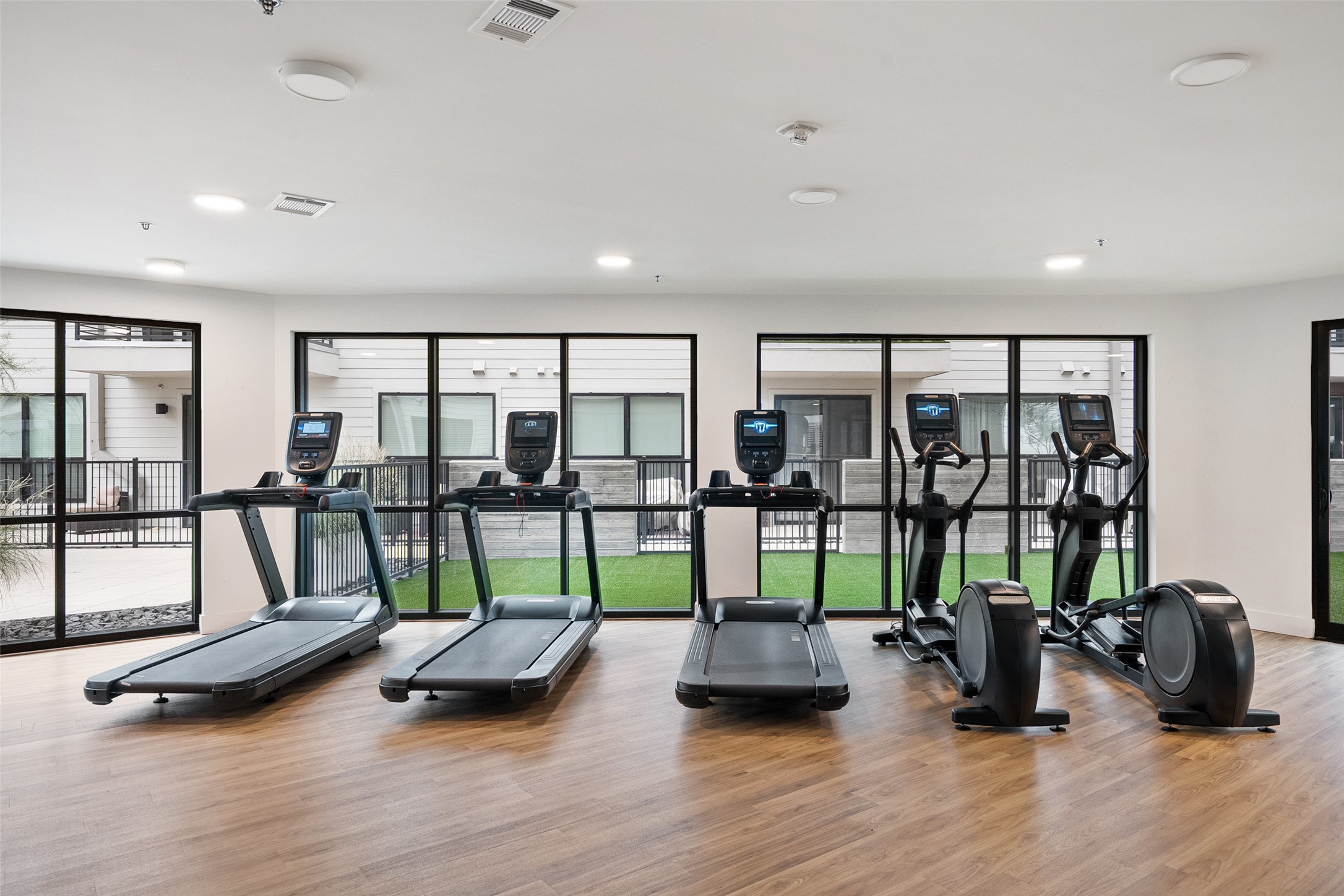 1701 Simond Avenue, Unit 305 Austin, TX 78723 - Photo 21 of 31 a room with gym equipment and a large window