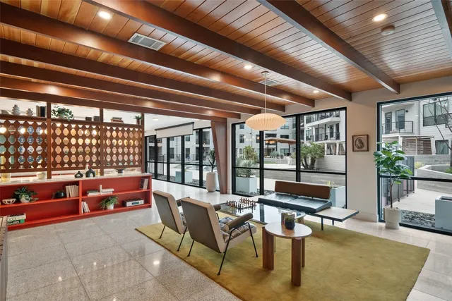 a reading room with furniture and large windows