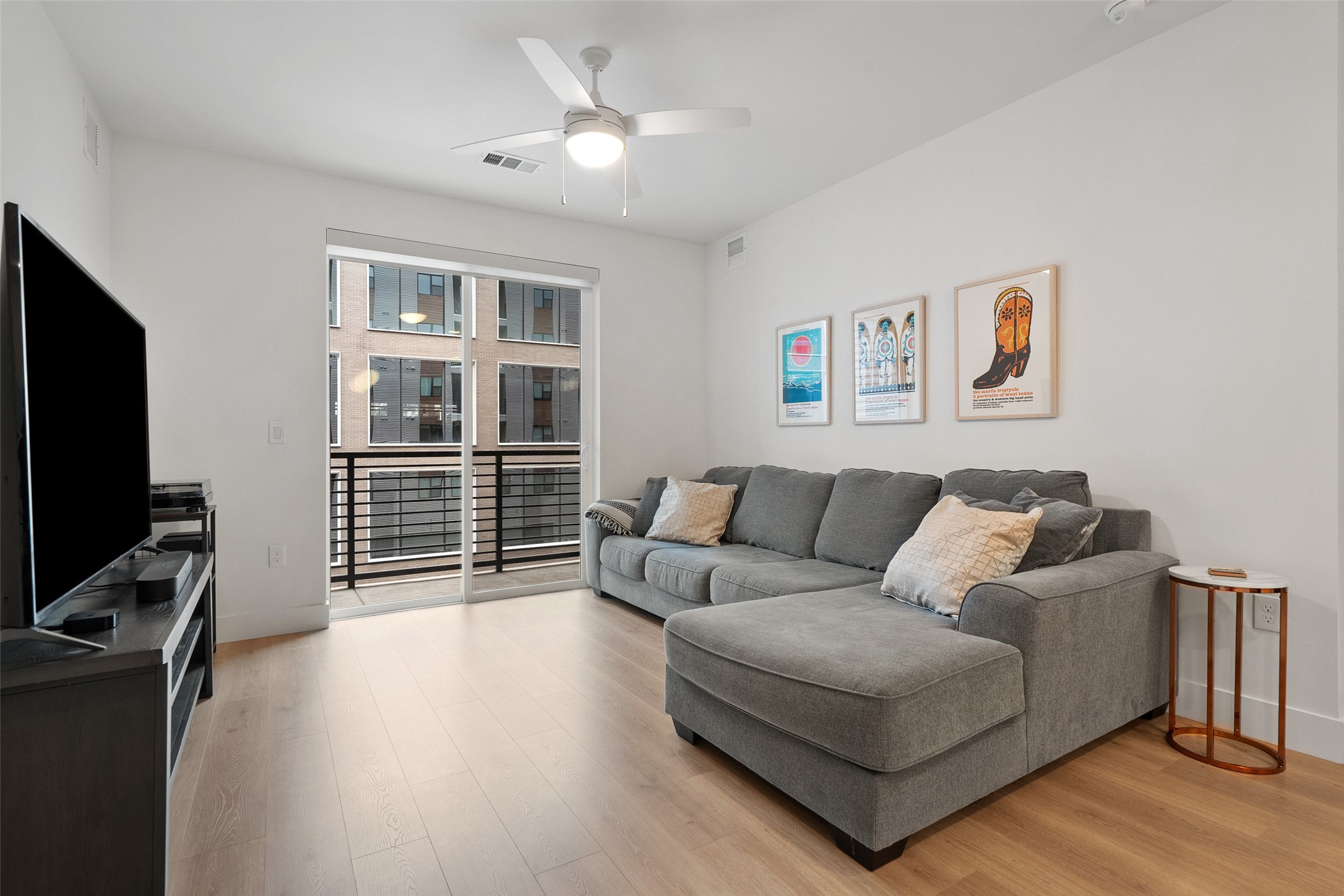 1701 Simond Avenue, Unit 305 Austin, TX 78723 - Photo 4 of 31 a living room with furniture a flat screen tv and a window