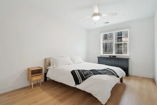 a bedroom with a bed and a night stand