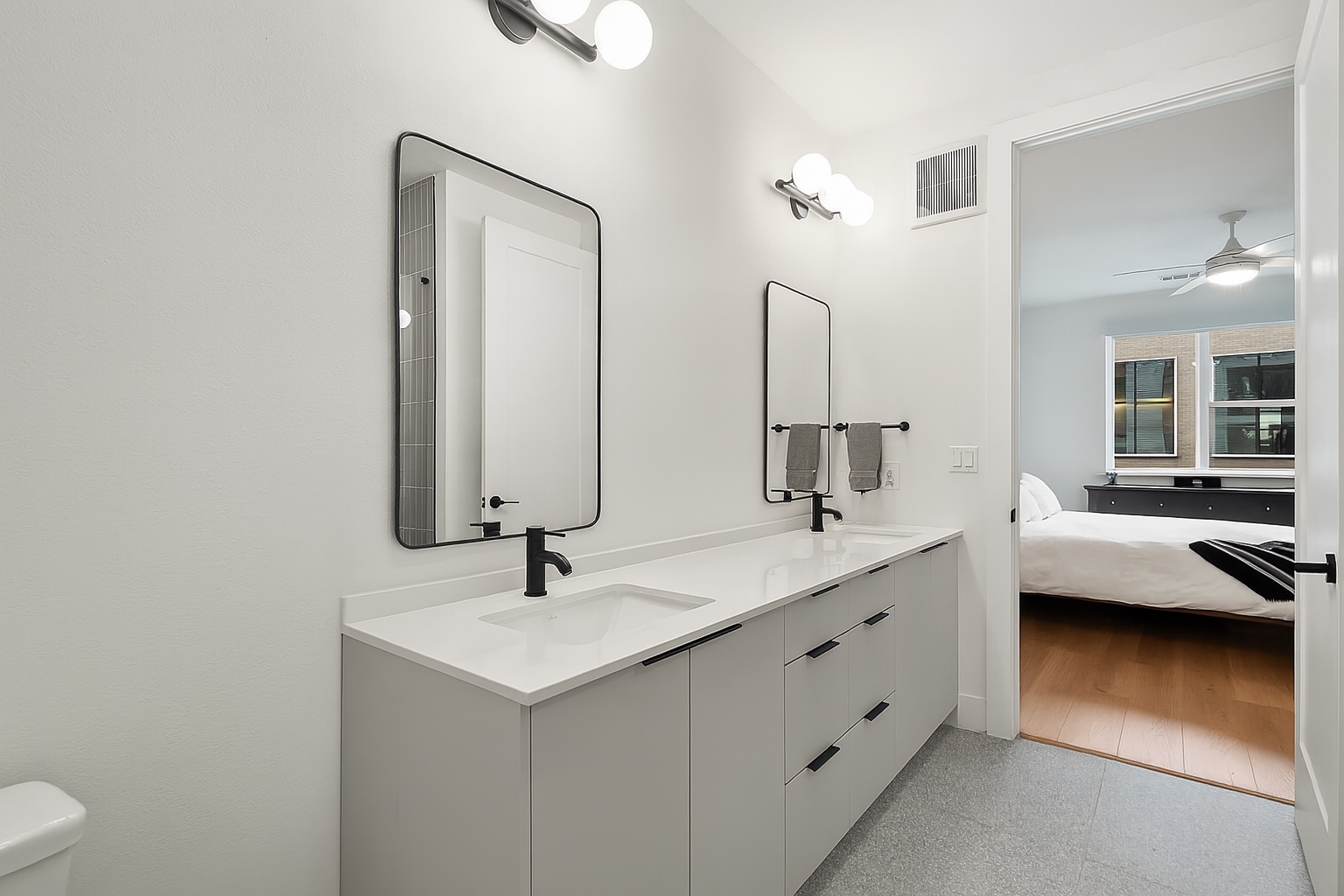 1701 Simond Avenue, Unit 305 Austin, TX 78723 - Photo 7 of 31 a bathroom with a double vanity sink and mirror
