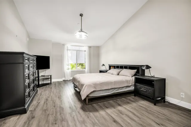 a bedroom with a bed and a flat screen tv