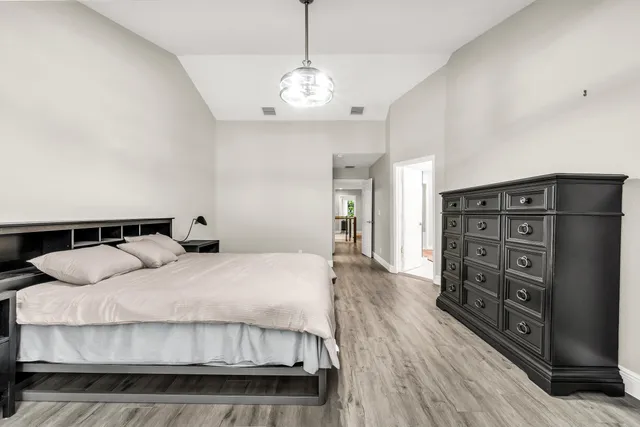 a spacious bathroom with a granite countertop sink a mirror and a shower
