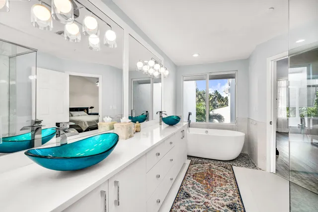 a bathroom with a granite countertop sink a toilet a mirror and shower